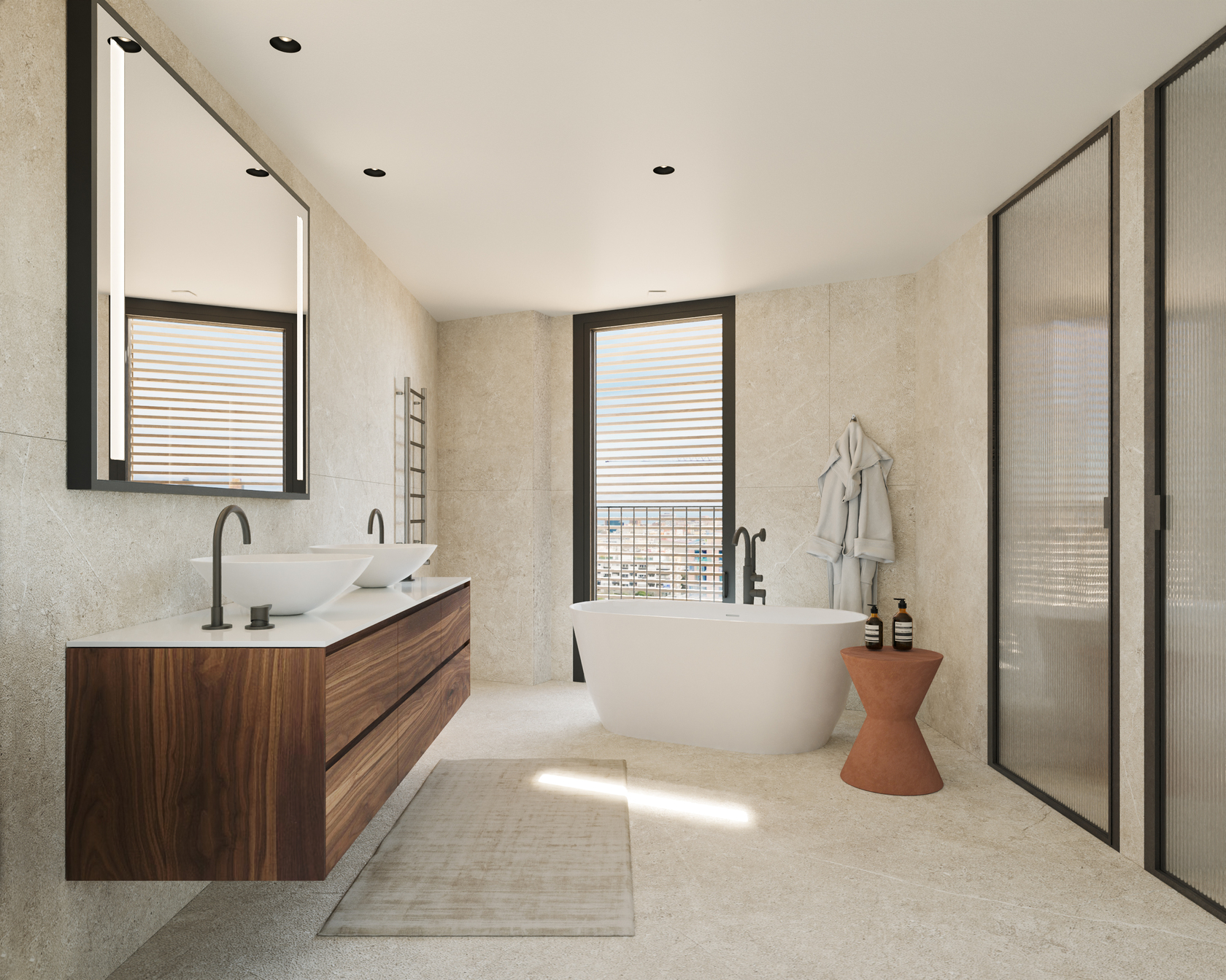 Master bathroom with a floating walnut double vanity, two white vessel basins and a freestanding white bathtub, in beige stone with fluted glass doors and a tall window with wooden shutters.